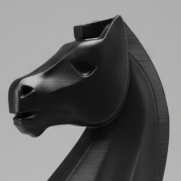 A matte black chess knight piece, made of plastic, standing against a neutral gray studio background.