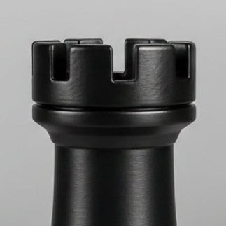 Close-up of a matte black rook chess piece photographed against a light gray background.