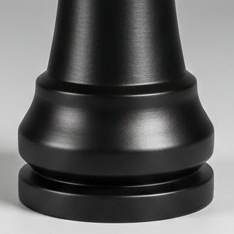 A large black chess rook standing upright on a light gray gradient background.