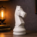 Decorative knight chess piece sculpture on a wooden shelf with plants and a map in the background