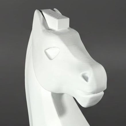 Close up shot of a white chess knight piece, shown from a three-quarters perspective against a dark gray gradient background.