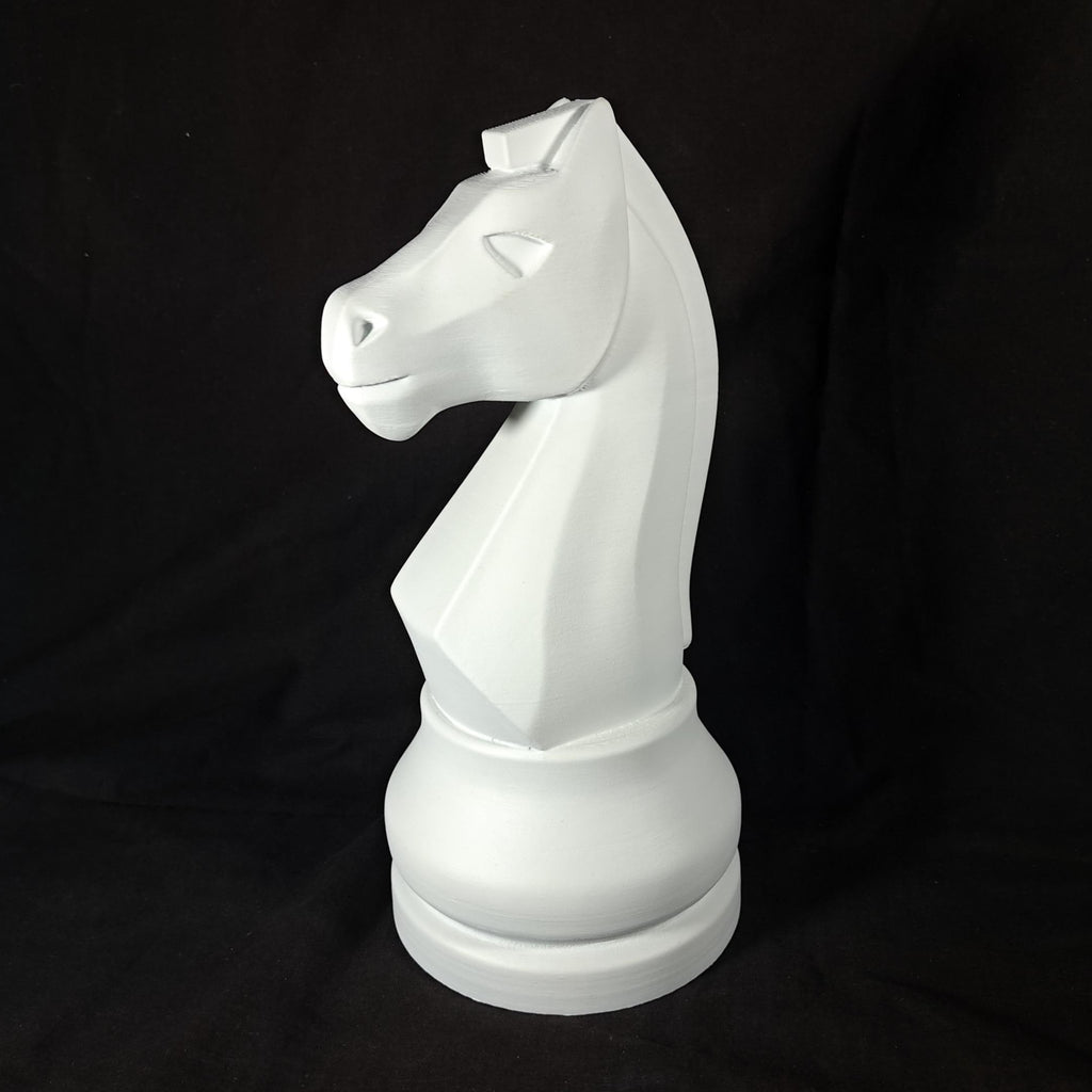 White knight chess piece on a black background