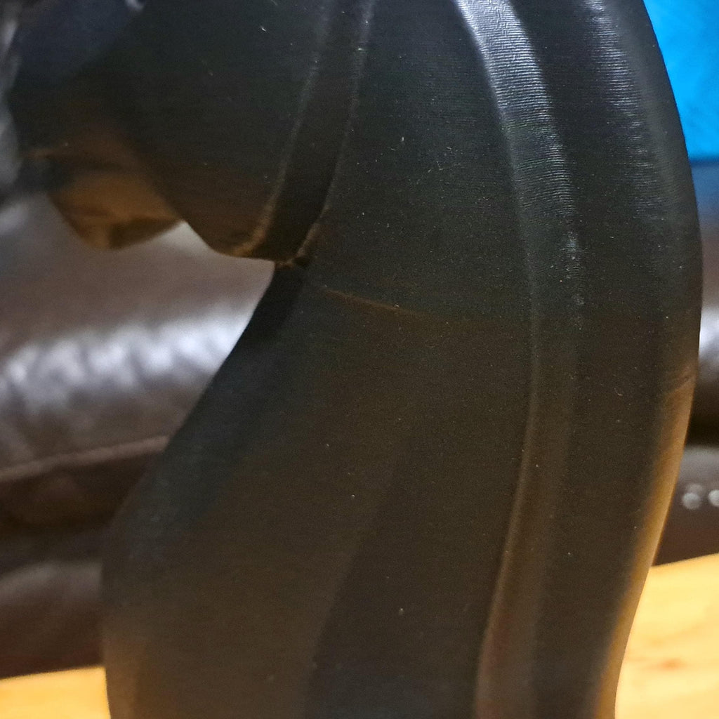 Close-up shot of the back of a black knight chess piece