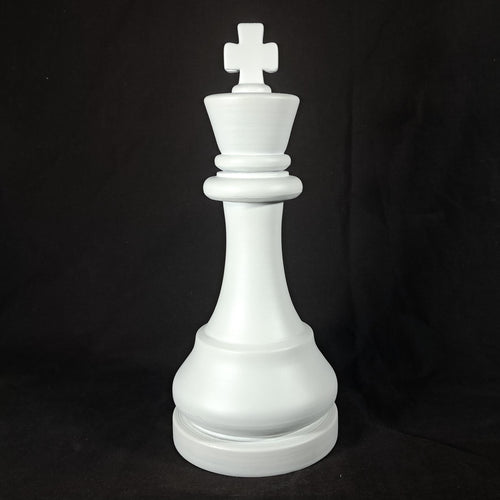 White king chess piece on a black background