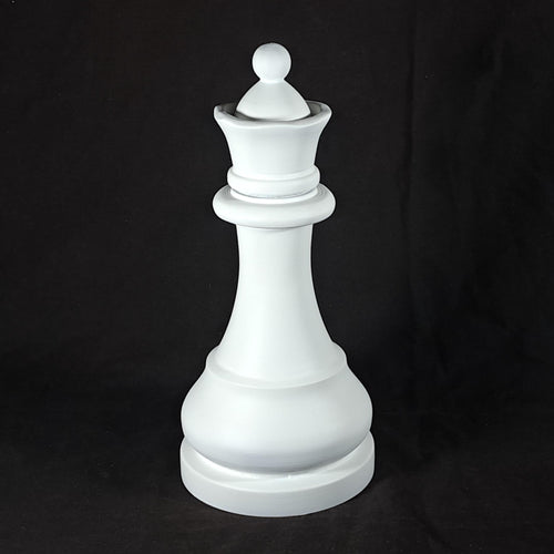 White queen chess piece on a black background