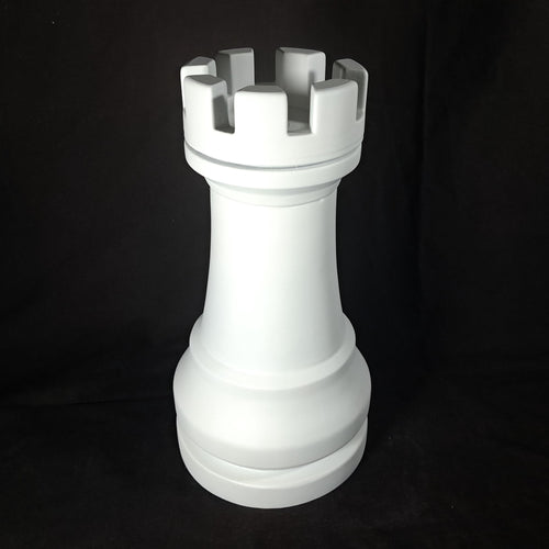 White chess piece resembling a king on a black background