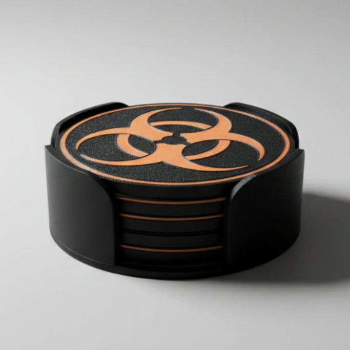 Black and orange biohazard symbol coasters on a grey .background