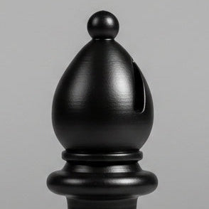 A close-up of a black decorative bishop chess piece, shown against a plain gray background.
