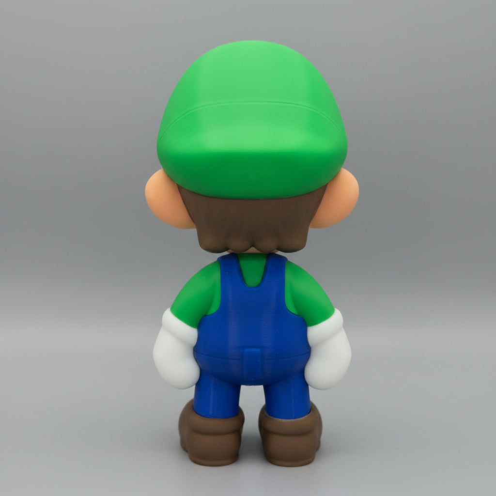 Toy figure of luigi with a green hat and blue overalls on a grey background