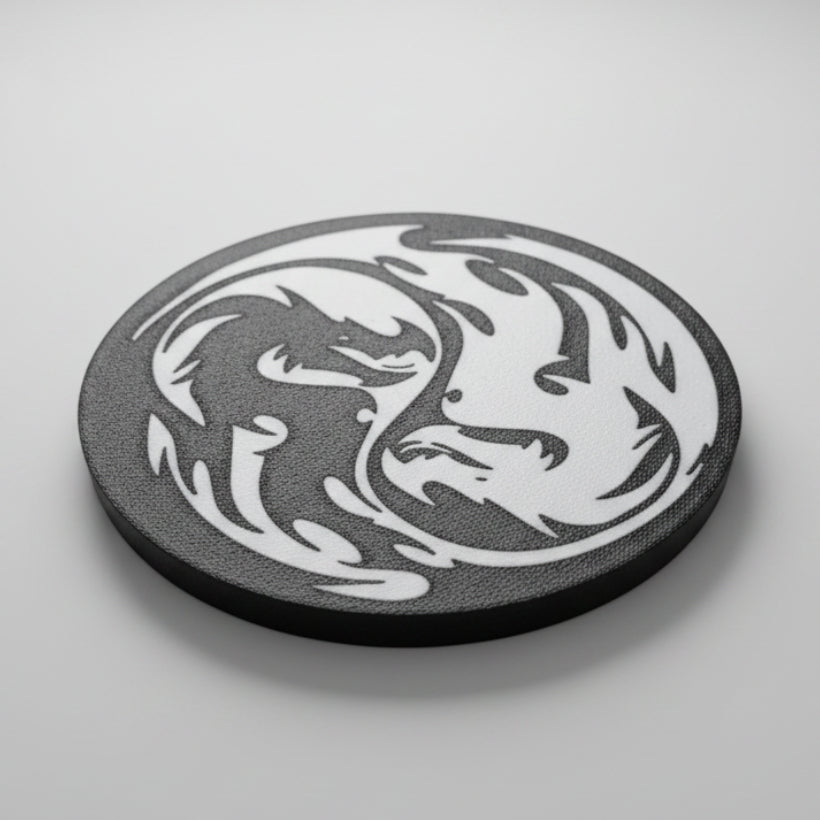 Black and white dragon coaster on a grey background.