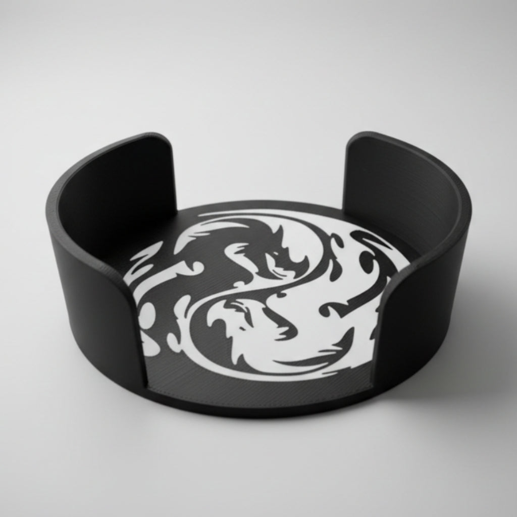 Black and white dragon coaster holder on a grey background.