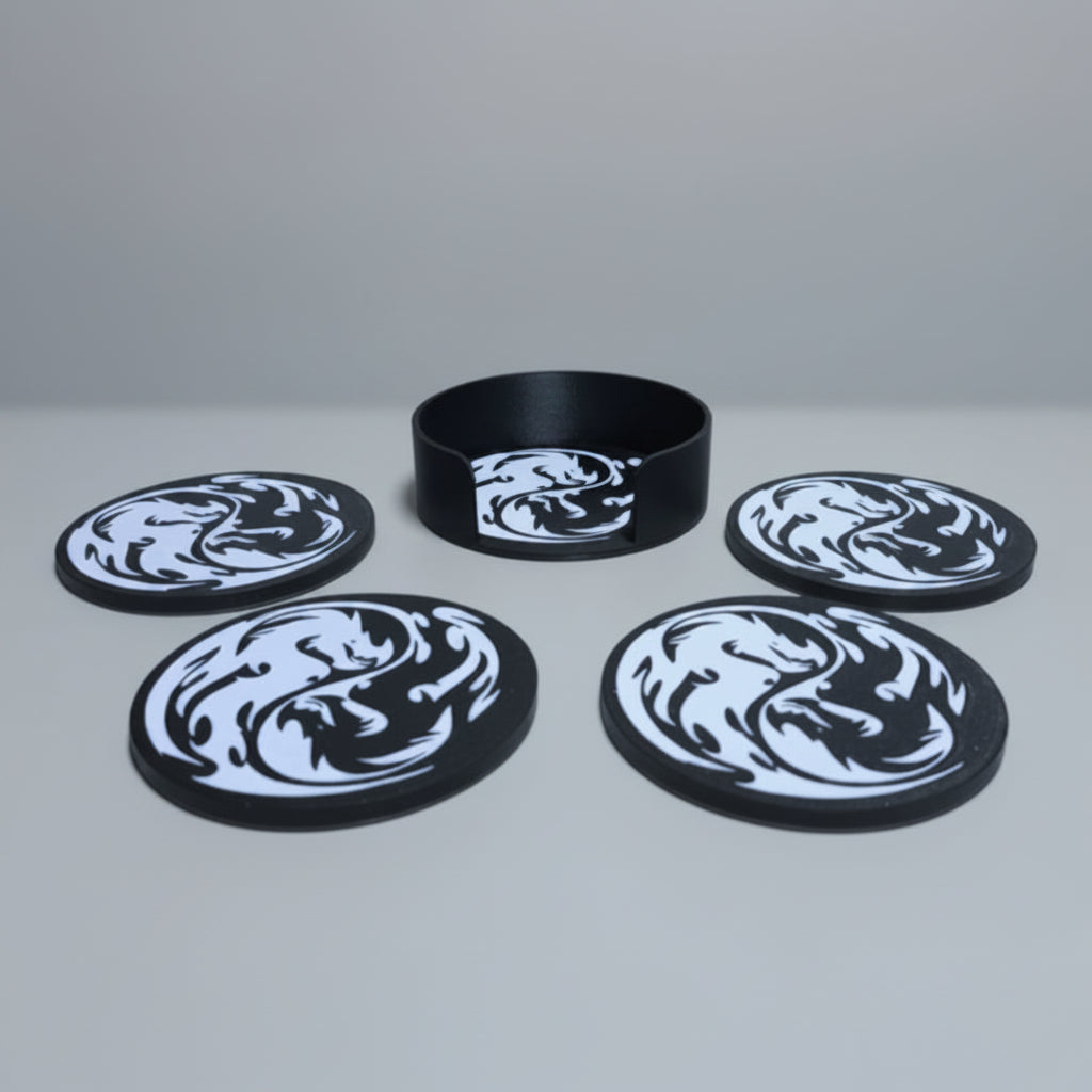 Five black and white coasters with a dragon design on a grey background.