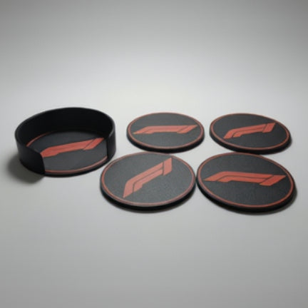 Four black coasters and holder featuring the red F1 logo, arranged on a grey background.