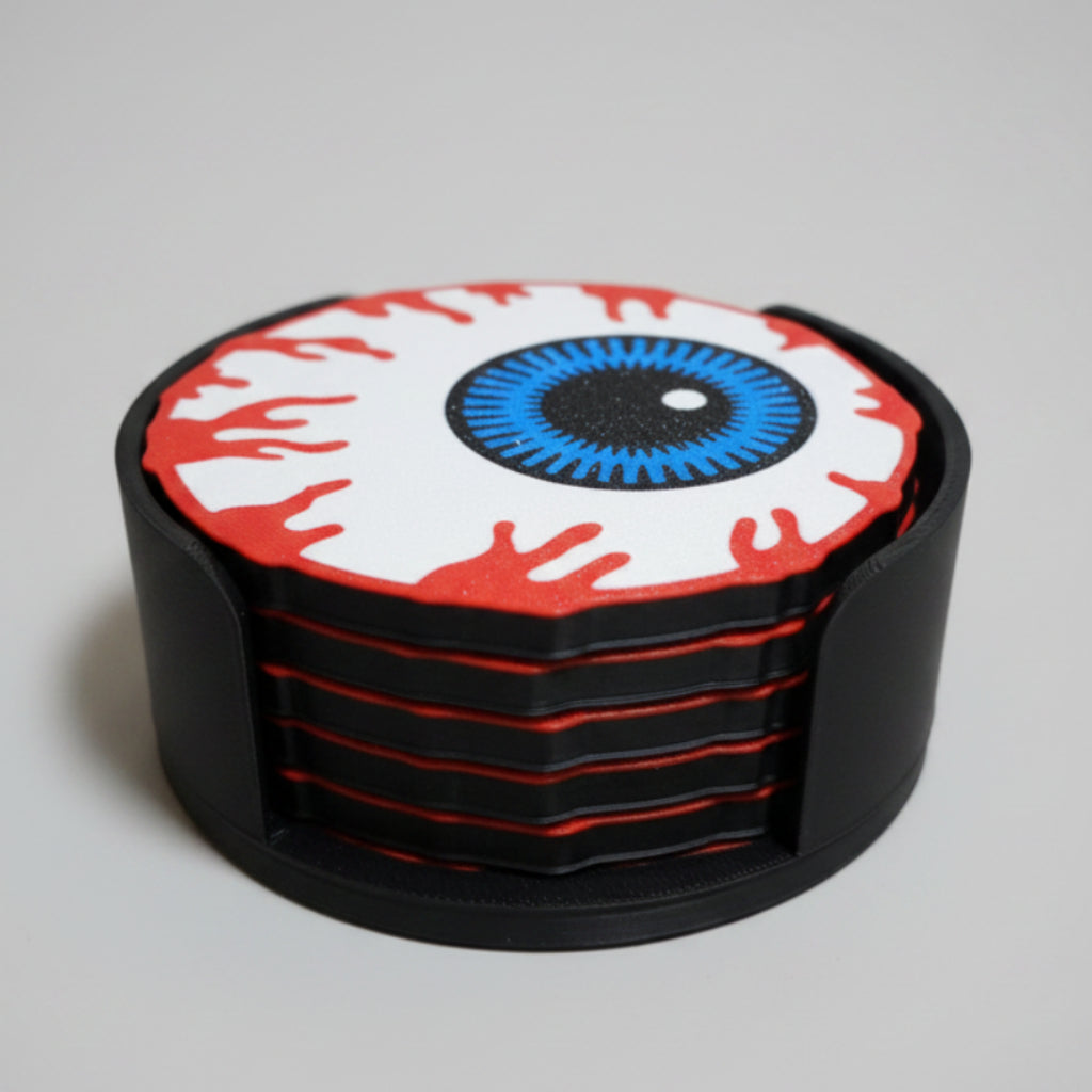 Stack of eyeball coasters with a unique design on a grey background.