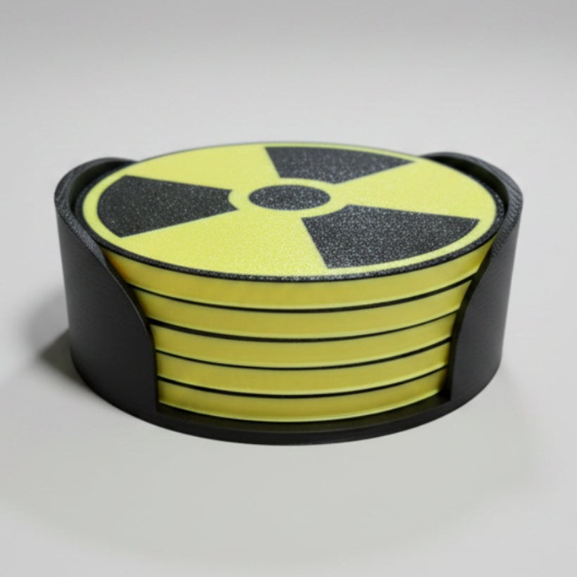 Yellow and black radiation symbol coaster set on a grey background.