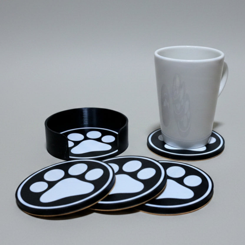 Paw print coasters on a grey background.