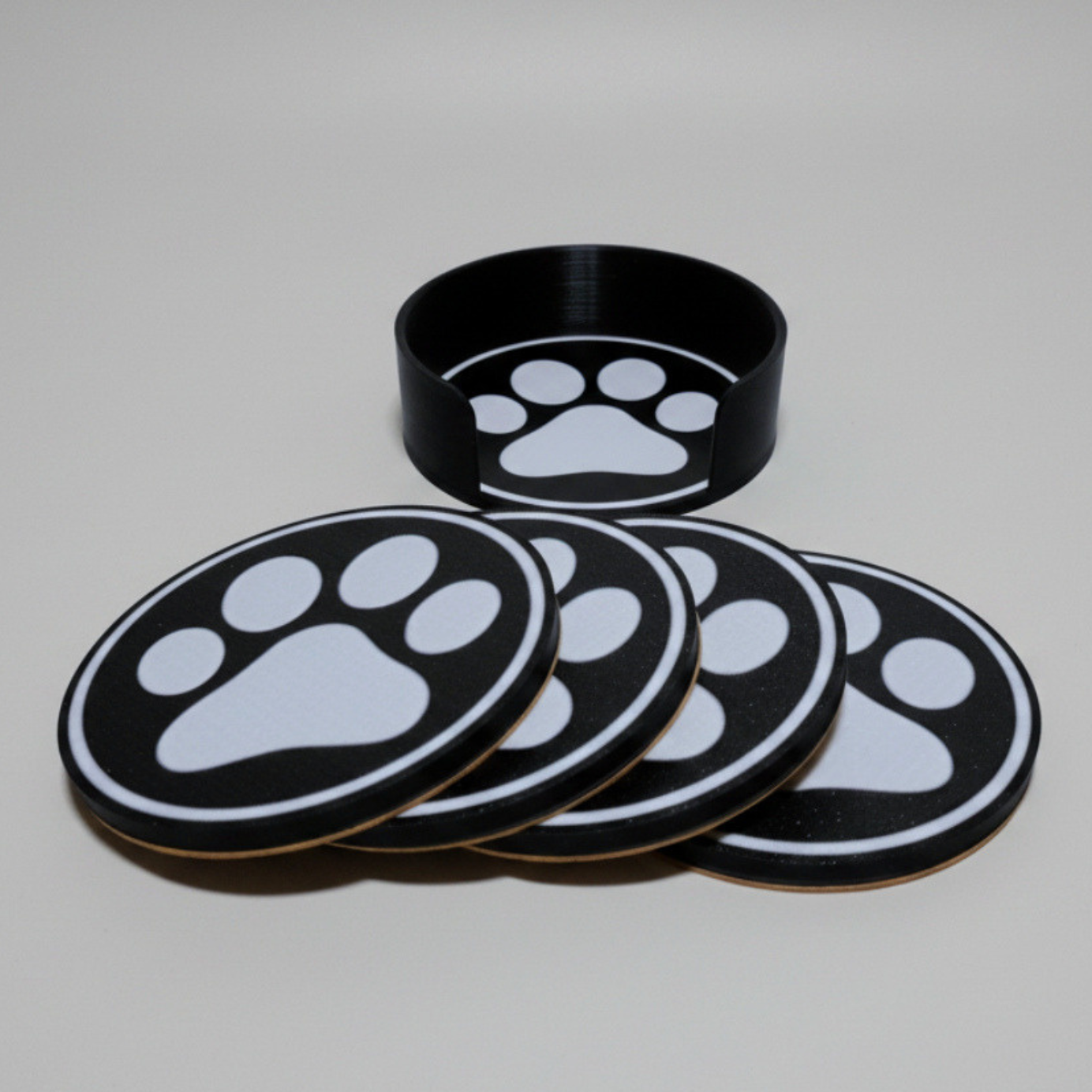 Paw Print Coaster set on a grey background.