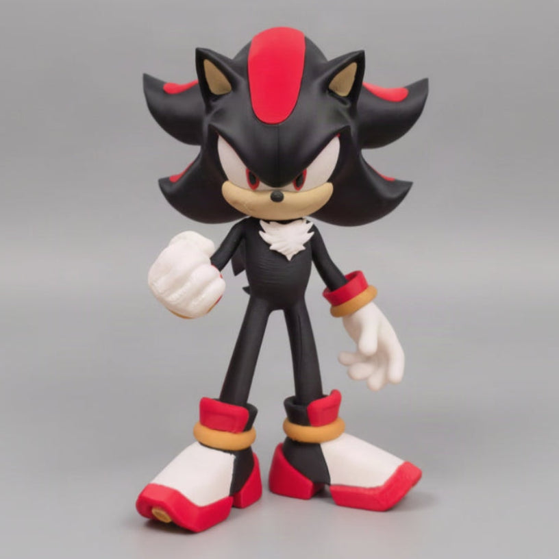 A  Shadow the Hedgehog figure posed standing upright, with black fur, red accents, white gloves and shoes, and tan muzzle and ear interiors, set against a gray background.