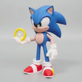 Sonic the hedghog holding a yellow ring with a grey background