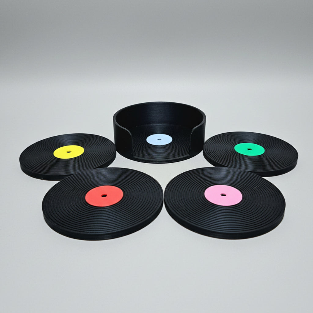 Five black vinyl records with colored center on a grey background.