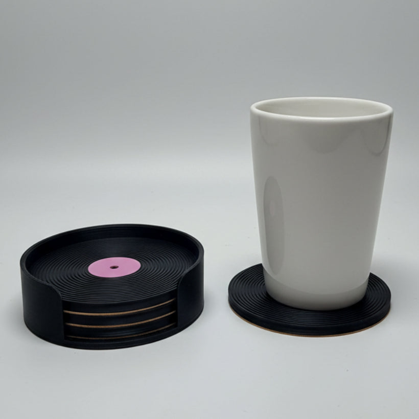 Vinyl record and a mug on a grey background.