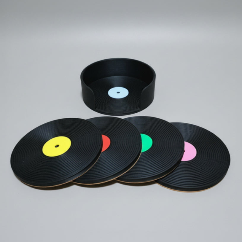 Set of vinyl record coasters on a grey background.