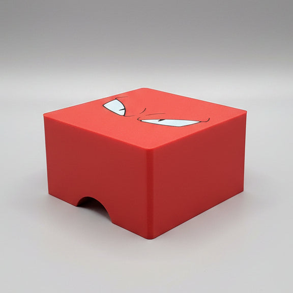 3D printed red Pokémon-inspired trading card deck box lid with angry eyes design, studio shot.