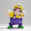 Wario figure in a fighting pose on a grey background.