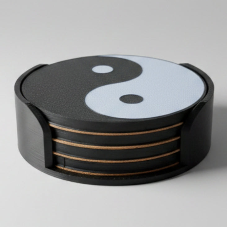 Black and white yin yang coasters on a grey background.