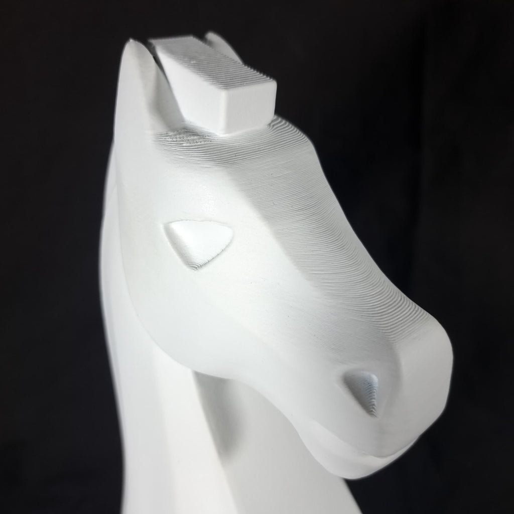 White knight chess piece on a black background